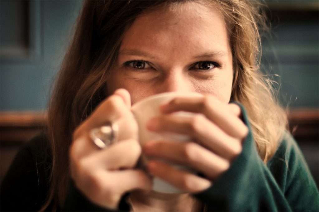 A woman drinking coffee.