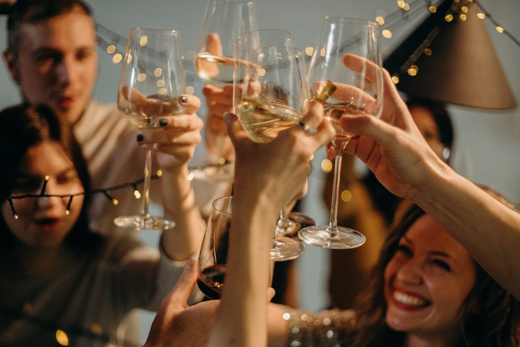 People making toast with wine.